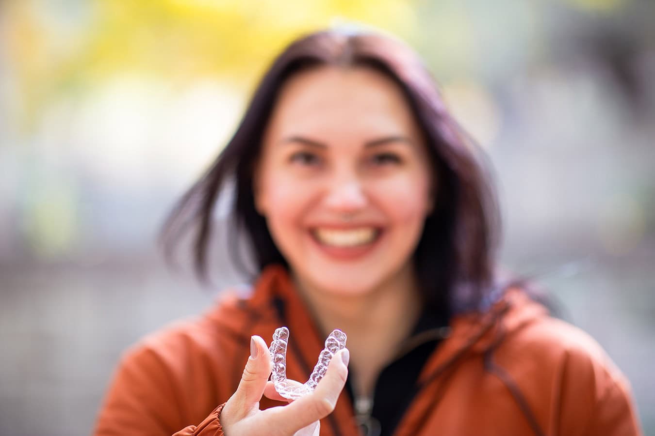 Happy woman holding Invisalign