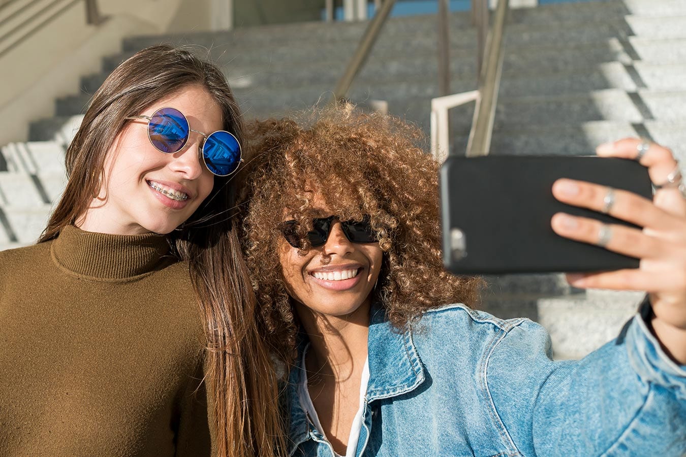 Friends taking selfie one with braces